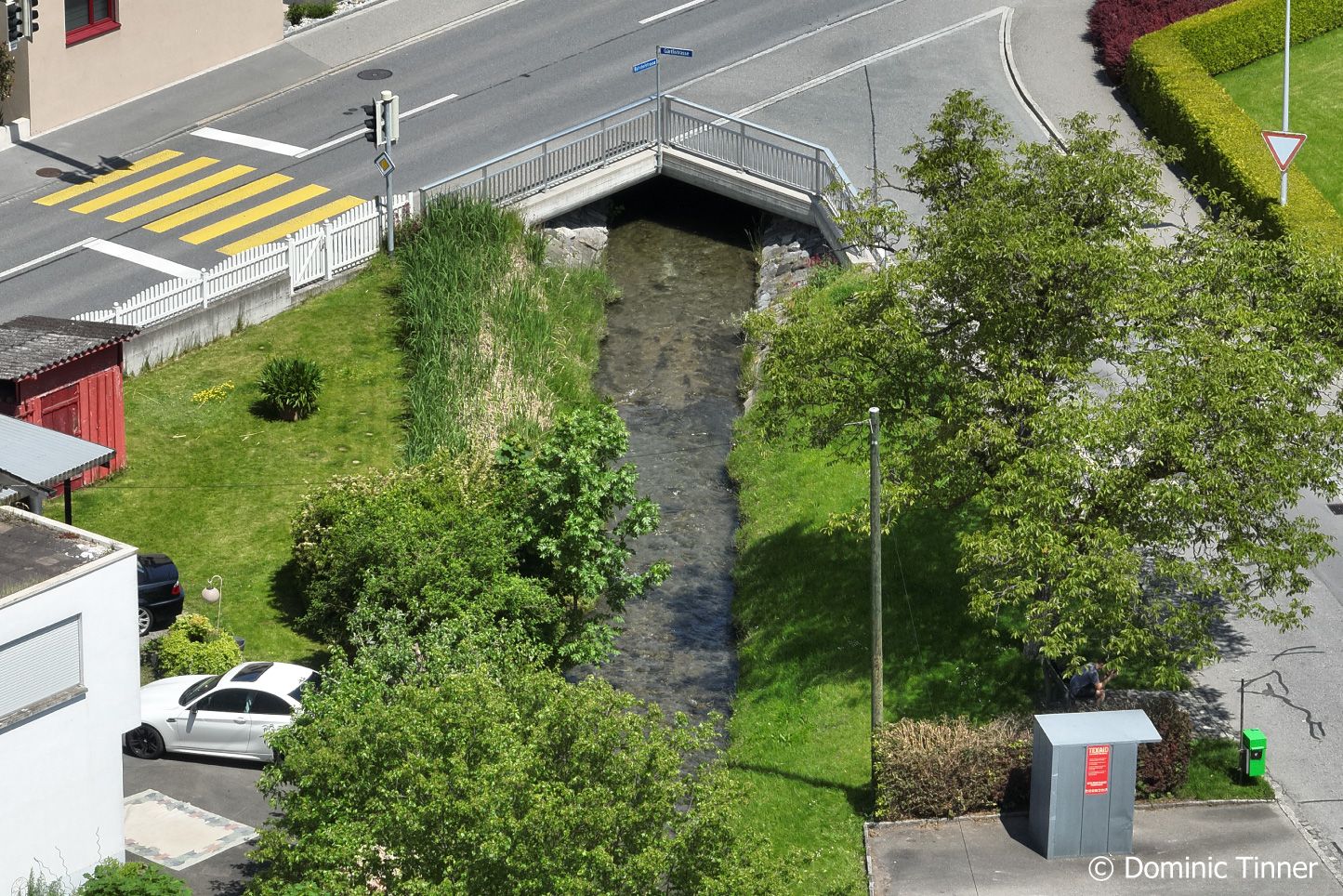 Luftaufnahme vom begradigten Sevelerbach, der unter einer Brücke durchfliesst.